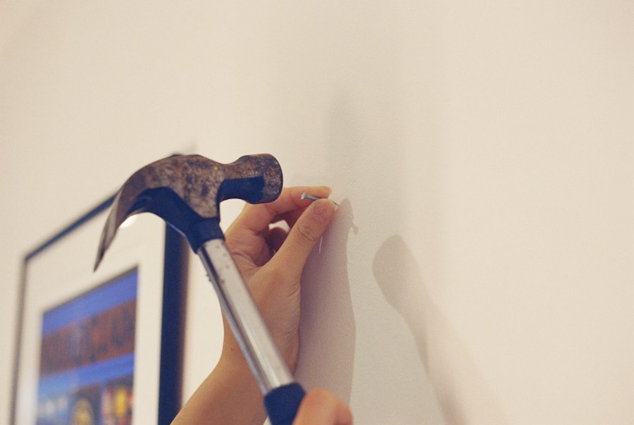 Hanging a picture with hammer and nail